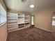 Bedroom with carpet, bright natural light, and built-in shelves and cabinets along one wall at 5627 Oakland Dr, Tampa, FL 33617