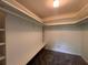 Walk-in closet has carpet flooring, lighting and shelving at 5627 Oakland Dr, Tampa, FL 33617