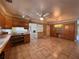 Spacious kitchen blending into an open floor plan with tile flooring and wood cabinetry at 5627 Oakland Dr, Tampa, FL 33617