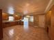 Spacious kitchen with tile floors, wood cabinets, and access to a screened porch at 5627 Oakland Dr, Tampa, FL 33617