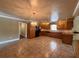 Open kitchen with tile flooring, wooden cabinets, and modern appliances at 5627 Oakland Dr, Tampa, FL 33617