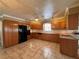 Open kitchen with tile floors, wood cabinetry, and stainless steel appliances at 5627 Oakland Dr, Tampa, FL 33617