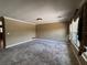 Spacious living room featuring neutral carpet, crown molding, and large windows at 5627 Oakland Dr, Tampa, FL 33617