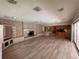 An open living area with wood floors, fireplace, and access to an outdoor patio at 5627 Oakland Dr, Tampa, FL 33617