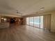 Open-concept living space with wood floors, leading to the kitchen and screened in patio with pool views at 5627 Oakland Dr, Tampa, FL 33617