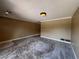 Open-concept living room with neutral carpet and traditional light fixture at 5627 Oakland Dr, Tampa, FL 33617