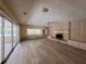 Open living room with hardwood floors, fireplace, and view of screened in patio at 5627 Oakland Dr, Tampa, FL 33617
