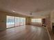 Bright living room featuring a fireplace, built-in shelving, wood flooring, and sliding glass doors to the pool at 5627 Oakland Dr, Tampa, FL 33617