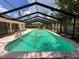 Inviting screened in pool for outdoor enjoyment with a light pink surrounding concrete patio at 5627 Oakland Dr, Tampa, FL 33617