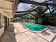 Enclosed pool with screen for outdoor enjoyment and privacy with a light pink concrete patio at 5627 Oakland Dr, Tampa, FL 33617