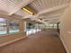 Spacious sun room with ceiling fan, multiple sliding glass doors, and pool views at 5627 Oakland Dr, Tampa, FL 33617