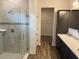 Bathroom featuring glass-enclosed shower, double sinks and granite countertops at 3441 Gramercy Ln, Spring Hill, FL 34609