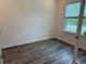 Bright bedroom with wood floors and a large window offering natural light at 3441 Gramercy Ln, Spring Hill, FL 34609