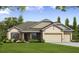Charming one-story home with a manicured lawn and a two-car garage at 3441 Gramercy Ln, Spring Hill, FL 34609