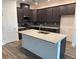 Modern kitchen showcasing dark cabinets, granite countertops, and stainless steel appliances at 3441 Gramercy Ln, Spring Hill, FL 34609