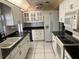 Functional kitchen with white cabinets, black countertops, and modern appliances at 4650 Orlando Cir, Bradenton, FL 34207