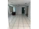 Spacious living room with tiled floors, natural light and access to another room at 4650 Orlando Cir, Bradenton, FL 34207