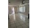 Bright living room with tiled floor, large windows, and access to the outdoors at 4650 Orlando Cir, Bradenton, FL 34207