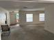 Spacious living room with neutral carpet, large windows, and ample natural light at 4650 Orlando Cir, Bradenton, FL 34207