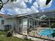 Backyard view with a screened-in pool and lush landscaping at 4650 Orlando Cir, Bradenton, FL 34207