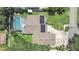 Aerial shot of a home with a screened-in pool, solar panels, and a well-maintained driveway and yard at 2531 Lake Ellen Dr, Tampa, FL 33618
