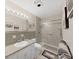 Bathroom featuring a shower with sliding glass door, integrated sink and a full-width mirror at 2531 Lake Ellen Dr, Tampa, FL 33618