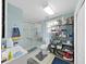 Bright bathroom features a glass-enclosed shower, white fixtures, and shelving for storage at 2531 Lake Ellen Dr, Tampa, FL 33618