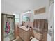 Bathroom with vintage pink tiling, window, mirrored cabinet, and glass-enclosed shower at 2531 Lake Ellen Dr, Tampa, FL 33618