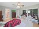 Bedroom featuring a ceiling fan, closet with mirrored doors, and adjacent bathroom at 2531 Lake Ellen Dr, Tampa, FL 33618