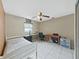 Bedroom with tiled floor, a ceiling fan, window, and a desk with chair at 2531 Lake Ellen Dr, Tampa, FL 33618