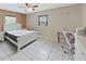 Bedroom with tiled floor, a ceiling fan, and a large window at 2531 Lake Ellen Dr, Tampa, FL 33618