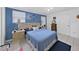 Cozy bedroom featuring blue walls, tile floors, a comfortable bed, and ample closet space at 2531 Lake Ellen Dr, Tampa, FL 33618