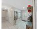 Bright foyer with tile flooring, coat rack, decorative mirror, and front door with glass inset at 2531 Lake Ellen Dr, Tampa, FL 33618