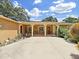 Charming home with covered porch, comfortable seating, and verdant landscaping at 2531 Lake Ellen Dr, Tampa, FL 33618