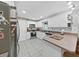 Well-lit kitchen featuring white cabinets, stainless steel appliances, and tile floors at 2531 Lake Ellen Dr, Tampa, FL 33618