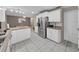 Spacious kitchen area featuring a stainless steel refrigerator, white cabinets, and ample counter space at 2531 Lake Ellen Dr, Tampa, FL 33618