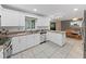 Well-lit kitchen area with white cabinets, stainless steel appliances, and tiled backsplash near the dining room at 2531 Lake Ellen Dr, Tampa, FL 33618