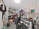 Small laundry room featuring modern washer and dryer appliances and storage shelving at 2531 Lake Ellen Dr, Tampa, FL 33618