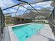 Inviting screened-in pool area with clear blue water, surrounded by a spacious deck for relaxation and entertainment at 2531 Lake Ellen Dr, Tampa, FL 33618