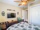 Comfortable bedroom featuring a ceiling fan, TV, and view to the entryway and ensuite bathroom at 2904 Sanchez St, Tampa, FL 33605