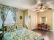 Bright bedroom with a leafy comforter, ceiling fan, and a vanity desk at 2904 Sanchez St, Tampa, FL 33605