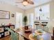 Bright dining room featuring seating for six, enhanced by unique lighting, adjacent to kitchen bar, hardwood floors at 2904 Sanchez St, Tampa, FL 33605