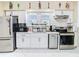 Bright kitchen features white cabinets, stainless steel appliances, and a large window for natural light at 2904 Sanchez St, Tampa, FL 33605
