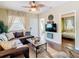 Comfortable living room with a large sectional sofa, stylish curtains, ceiling fan, and view into an adjacent bedroom at 2904 Sanchez St, Tampa, FL 33605