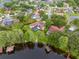 Aerial view of property showcasing pool, lake access, boat dock, and well-maintained surrounding neighborhood at 15007 Laurel Cove Cir, Odessa, FL 33556