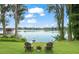 Picturesque backyard view with lake access, chairs, and a jet ski, perfect for enjoying waterfront living at 15007 Laurel Cove Cir, Odessa, FL 33556