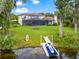 Spacious backyard with screened pool, kayak, jet ski, and waterfront access, ideal for outdoor recreation at 15007 Laurel Cove Cir, Odessa, FL 33556