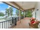Covered balcony with seating overlooks the lake at 15007 Laurel Cove Cir, Odessa, FL 33556