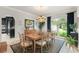Charming dining room featuring a wooden table, chandelier, and large window with natural light at 15007 Laurel Cove Cir, Odessa, FL 33556
