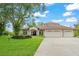 Charming home with a three-car garage, manicured lawn, and inviting curb appeal at 15007 Laurel Cove Cir, Odessa, FL 33556